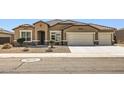 Inviting single-story home featuring a three car garage and low maintenance desert landscaping at 13811 W Paso Trl, Peoria, AZ 85383