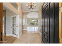 Bright foyer with marble floors, chandelier, and views to the backyard at 1507 E Treasure Cove Dr, Gilbert, AZ 85234