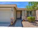 Inviting front entrance with desert landscaping and stone accents creating curb appeal at 17418 N Carmen Ave, Maricopa, AZ 85139