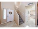 Inviting entryway with tile floors, a staircase, and a decorated front door at 1750 W Union Hills Dr # 8, Phoenix, AZ 85027