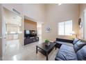 Spacious living room featuring high ceilings, tile floors, and a comfortable leather sofa at 1750 W Union Hills Dr # 8, Phoenix, AZ 85027