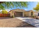 Low-angle, three-quarter view of a single-story stucco home with a two-car garage and desert landscaping at 18417 W Elm St, Goodyear, AZ 85395