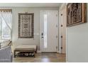 Inviting entryway with a white door, decorative rug, bench with shoe storage, and neutral wall color at 2024 W Trotter Trl, Phoenix, AZ 85085