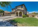 Attractive two-story home with a tidy lawn, desert landscaping, and charming architectural details at 21288 E Via Del Sol --, Queen Creek, AZ 85142