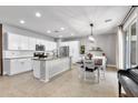 Open-concept kitchen featuring white cabinetry, granite countertops, and an adjacent dining area at 21288 E Via Del Sol --, Queen Creek, AZ 85142