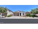 Charming one-story home boasting a well-kept lawn, desert landscaping, and a spacious two-car garage at 21595 S 225Th Way, Queen Creek, AZ 85142