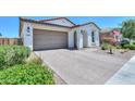 Beautiful home featuring desert landscaping, a two-car garage, and a covered entryway at 21595 S 225Th Way, Queen Creek, AZ 85142