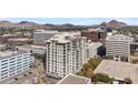 Multi-story building featuring multiple windows and balconies surrounded by lush landscaping at 2211 E Camelback Rd # 1203, Phoenix, AZ 85016