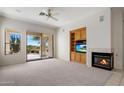 Inviting living room featuring a fireplace, built-in shelving, and sliding glass doors to the outdoors at 22231 N 51St St, Phoenix, AZ 85054