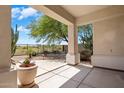 Relaxing covered patio area with desert landscaping, stone flooring and scenic views at 22231 N 51St St, Phoenix, AZ 85054