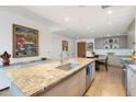 Open kitchen with granite countertops and modern appliances, with an eating bar and dining area at 2300 E Campbell Ave # 104, Phoenix, AZ 85016