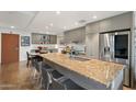 This modern kitchen features stainless steel appliances, a large island with seating, and stylish cabinetry at 2300 E Campbell Ave # 104, Phoenix, AZ 85016