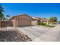 A beautiful home exterior features a well-maintained lawn and a spacious driveway at 233 W Sweet Shrub Ave, San Tan Valley, AZ 85140