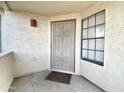 Close-up of the front door featuring security screen, exterior sconce, and window at 2333 E Southern Ave # 1101, Tempe, AZ 85282