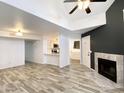 Open-concept living room features fireplace, tile floors, ceiling fan and modern lighting at 2333 E Southern Ave # 1101, Tempe, AZ 85282