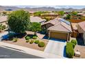 An aerial view of a home with solar panels, desert landscaping, and a tile roof at 26071 W Sequoia Dr, Buckeye, AZ 85396