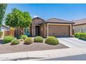 Charming single-story home with stone accents, a well-maintained front yard, and a two-car garage at 26071 W Sequoia Dr, Buckeye, AZ 85396