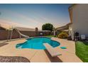 Backyard pool features a diving board and slide, perfect for summer fun at 2643 E Menlo St, Mesa, AZ 85213