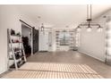 Bright open-concept living room showcasing tile floors and a decorative sliding barn door at 3256 E Maplewood St, Gilbert, AZ 85297