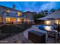 Backyard featuring a sparkling pool, covered patio, and lush landscaping, perfect for relaxing and entertaining outdoors at 3261 S Sunland Dr, Chandler, AZ 85248
