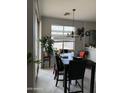 Cozy dining area with a marble dining table, leather chairs, and sliding glass doors at 3825 S 60 Dr, Phoenix, AZ 85043