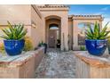 Inviting front entrance featuring a stone pathway and vibrant potted plants at 3830 N Red Sky Cir, Mesa, AZ 85207