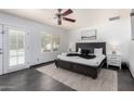 Inviting bedroom featuring a ceiling fan, neutral decor and door leading to pool at 4556 E Paradise Ln, Phoenix, AZ 85032