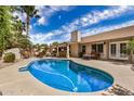 Sparkling pool with a covered patio and outdoor seating area at 4556 E Paradise Ln, Phoenix, AZ 85032