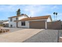 Well-kept, two-story home boasts an attached two-car garage and gravel landscaping at 4629 E Southern Ave, Phoenix, AZ 85042