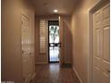 Hallway with wood-look floors leading to the front door at 4747 E Narrowleaf Dr, Gilbert, AZ 85298