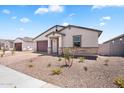 Inviting exterior view of a single-story home featuring a manicured desert landscape and a neutral color palette at 4811 W Hunter Trl, San Tan Valley, AZ 85144