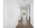 Bright hallway featuring neutral walls, tile flooring, and a view of the backyard through sliding glass doors at 4811 W Hunter Trl, San Tan Valley, AZ 85144