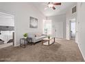 Bright living room featuring neutral tones, a ceiling fan, and views into a bedroom at 5136 E Evergreen St # 1142, Mesa, AZ 85205