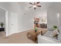Cozy living room with a ceiling fan that flows seamlessly into the kitchen and dining area at 5136 E Evergreen St # 1142, Mesa, AZ 85205