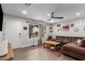 Inviting living room with a comfortable sofa, ceiling fan, and natural light at 5702 S Beck Ave, Tempe, AZ 85283