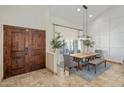 Dining room showcasing double door entry, stylish lighting, and seating for Gathering gatherings at 7469 E Timberlane Ct, Scottsdale, AZ 85258