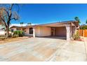 Exterior view featuring a carport and desert landscaping at 9227 N 36Th Dr, Phoenix, AZ 85051