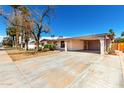 Exterior view of a single-story home with a carport and desert landscaping at 9227 N 36Th Dr, Phoenix, AZ 85051