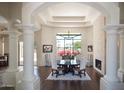 Elegant dining room with large windows, fireplace, and sophisticated decor is perfect for entertaining guests at 10800 E Cactus Rd # 34, Scottsdale, AZ 85259