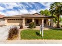 Inviting single-story home with a well-maintained front yard, covered entry, and a two-car garage at 12428 W Vermont Ct, Litchfield Park, AZ 85340