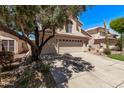 View of the home's side, featuring a long driveway, a three-car garage, and desert landscaping at 13270 N 93Rd Way, Scottsdale, AZ 85260