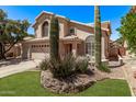 Charming home featuring desert landscaping, including cacti and rock features, enhancing its curb appeal at 13270 N 93Rd Way, Scottsdale, AZ 85260