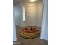 Bright entryway featuring neutral walls, tile flooring, and a vibrant, colorful round rug at 15225 N 100Th St # 1220, Scottsdale, AZ 85260