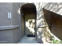 A close up shot of the unit's front door, with a covered entryway and the unit number, 1220, visible at 15225 N 100Th St # 1220, Scottsdale, AZ 85260