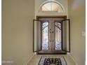 Inviting foyer showcasing tile floors and an elegant wrought iron double door entry at 15273 S 31St St, Phoenix, AZ 85048