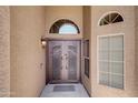 Up close view of the home's beautiful double door entry and its decorative wrought iron at 15273 S 31St St, Phoenix, AZ 85048