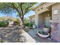 Inviting front entrance with desert landscaping, stone accents, and a covered porch area at 16861 N 106Th Way, Scottsdale, AZ 85255