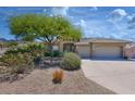 Charming single-story home featuring a three-car garage and desert landscaping in a well-maintained community at 16861 N 106Th Way, Scottsdale, AZ 85255