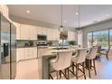 Modern kitchen with island, white cabinetry, stainless steel appliances and pendant lighting fixtures at 16861 N 106Th Way, Scottsdale, AZ 85255
