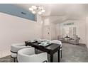Bright dining room with modern chandelier, table set for four, and cozy seating area at 18622 N 28Th Way, Phoenix, AZ 85050